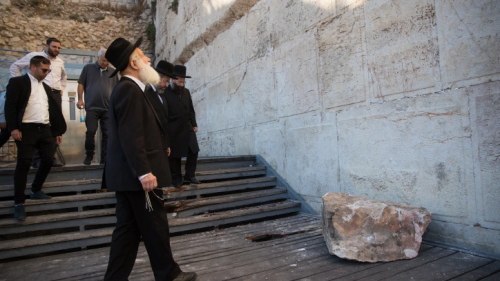 A Jewish man observes the site where a large chunk of stone dislodged from the Western Wall in Jerusalem's Old City at the mixed-gender prayer section on July 23, 2016. Photo by Yonatan Sindel/Flash90.