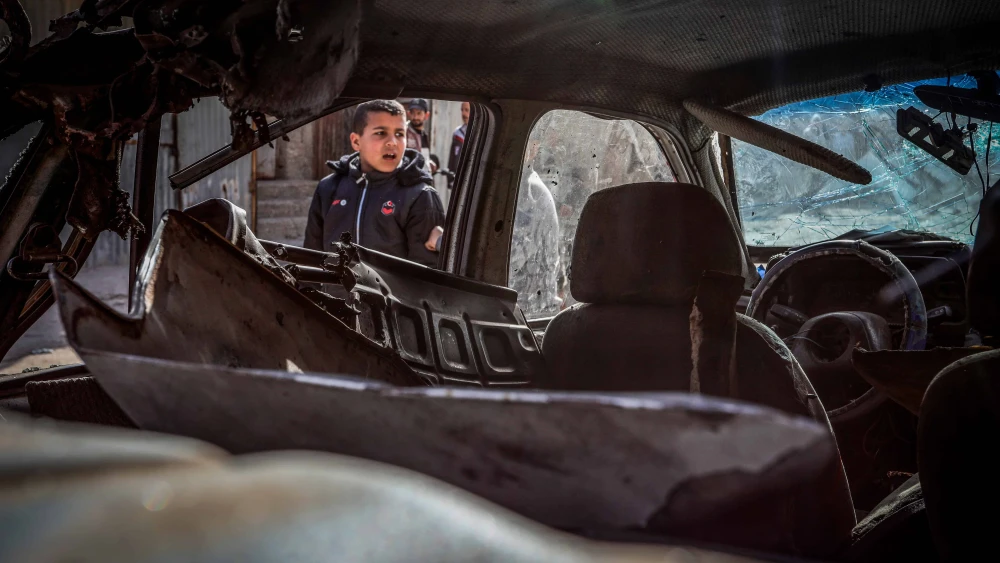 Palestinians outside a car after it was hit by an Israeli airstrike in Rafah, in the southern Gaza Strip, March 2, 2024. Photo by Abed Rahim Khatib/Flash90.