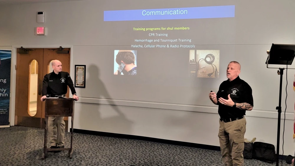 Police officers Michael Specht (left) and Roger Heath present critical safety information to Magen Chicago.