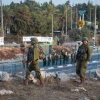 Soldiers guard a bus stop at the entrance to the Israeli town of Ofra in southern Samaria, Oct. 4, 2022. Credit: Flash90.