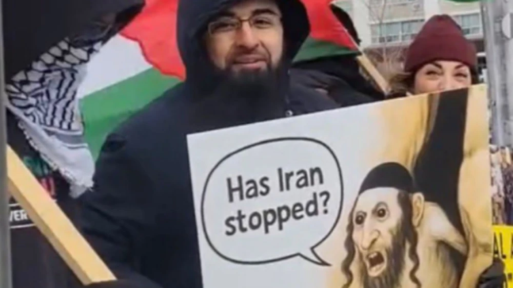 An antisemitic sign at an anti-Israel protest in Toronto shows a caricatured Orthodox Jewish man beside the words “Has Iran stopped?” on March 15, 2026. Source: @bnaibrithcanada/X.