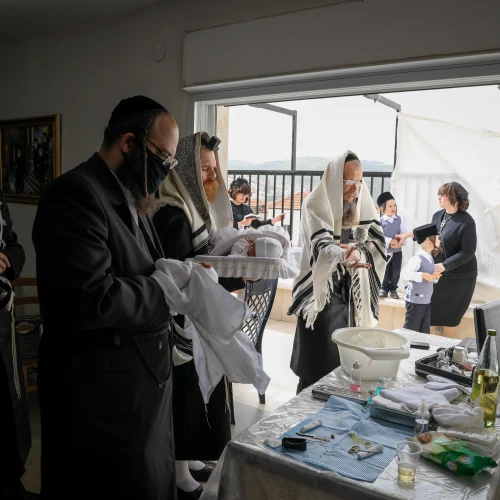 The Greenfeld family celebrate a brit milah at their home in Beitar Illit, Israel, on April 5, 2020. Photo by Nati Shohat/Flash90.