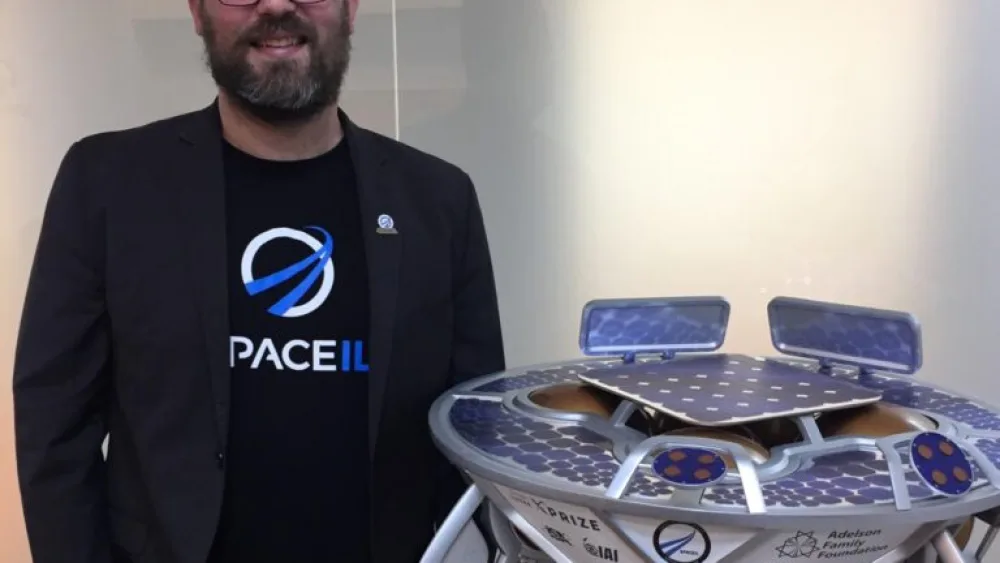 Kfir Damari next to a model of “Beresheet.” Photo by Diana Bletter.