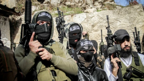 Masked Palestinians hold their guns during the funeral of Palestinian Jamil al-Kayyal, who was killed in clashes with Israeli forces in Nablus, Dec. 13, 2021. Photo by Nasser Ishtayeh/Flash90.