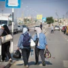 Palestinians who flee from their homes wait at the Rafah border crossing to Egypt in the southern Gaza Strip, on Oct. 14, 2023. Photo by Atia Mohammed/Flash90.