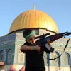 A Palestinian boy wearing a Hamas headband aims a toy gun during a rally after prayers at the Al-Aqsa mosque on the Temple Mount in Jerusalem, July 28, 2014. Photo by Sliman Khader/Flash90.