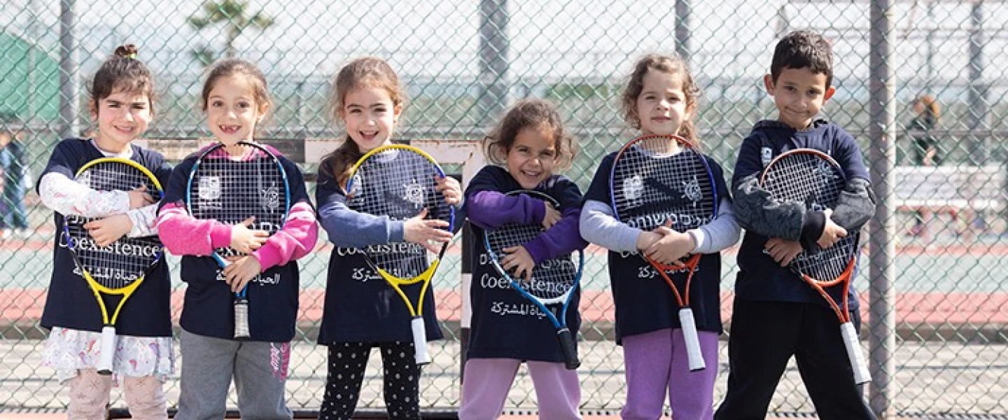 Players from the Israel Tennis & Education Centers wear coexistence-themed shirts. Credit: Israel Tennis & Education Centers.
