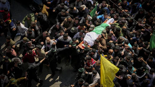 Masked terrorists from Hamas’s Izz ad-Din al-Qassam Brigades carry the body of slain terror commander Mazen Faqha during his funeral in Gaza City Saturday, March 25. Credit: Abed Rahim Khatib/Flash90.