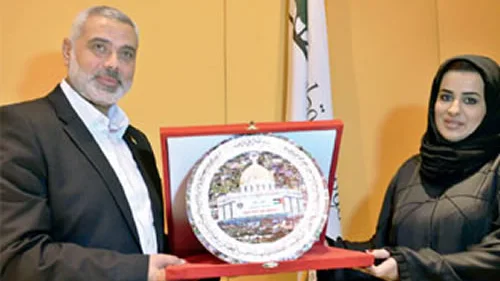 Qatar Foundation official Haya Al-Nassr, director of communications, awards Hamas leader Ismail Haniyeh (left) with a “victory shield” featuring the Dome of the Rock in Jerusalem. Credit: Middle East Forum.