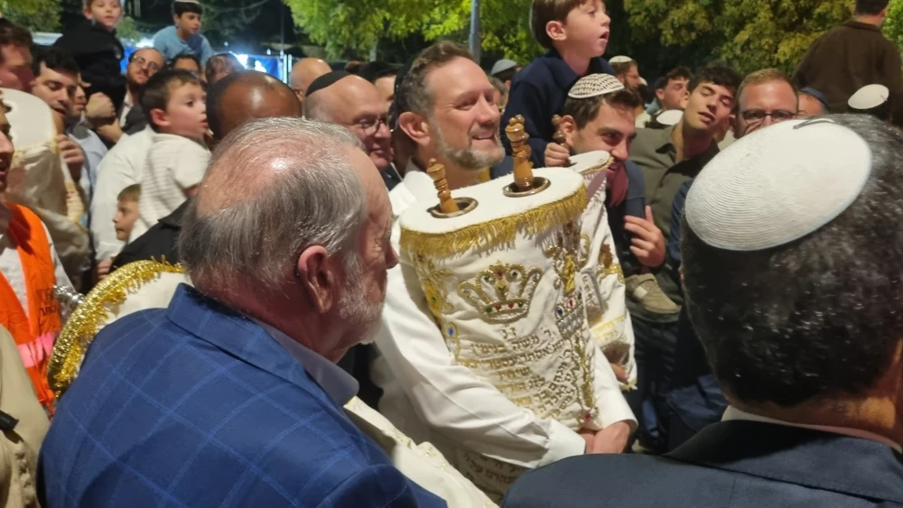 Rabbi Yehuda Seif, the head of Midreshet Torah v'Avodah, dances with a Torah at Liberty Bell Park in Jerusalem on Oct. 3, 2026. Photo by Sharon Altshul.
