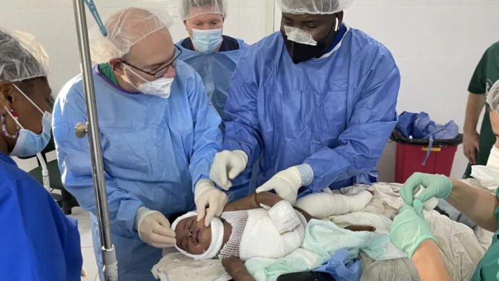 Dr. Josef Haik, second from left, working with Haitian physicians to treat a young burn victim, April 2022. Photo courtesy of Sheba Medical Center