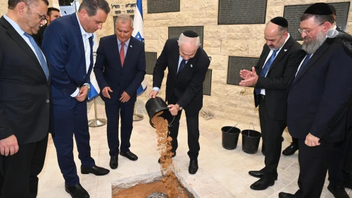 Israeli Prime Minister Benjamin Netanyahu helps out at a cornerstone-laying ceremony for a memorial hall on Mount Herzl in Jerusalem on April 19, 2023. Photo by Haim Zach/GPO.