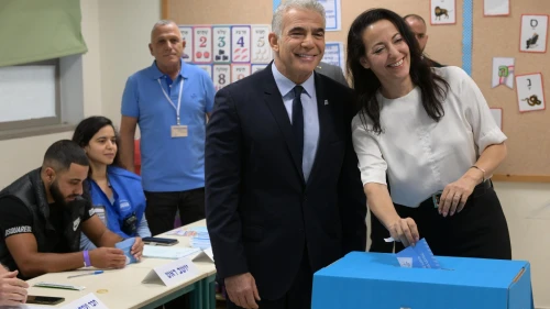 Israeli Prime Minister Yair Lapid and his wife Lihi vote in Israel's national election, Nov. 1, 2022. Credit: Amos Ben Gershom/GPO.