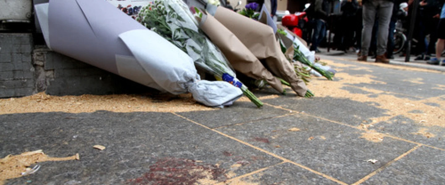 The Le Petit Cambodge restaurant—site of one of six coordinated Islamist terror attacks in Paris on Friday—with a makeshift memorial of flowers and blood staining the ground on the day after the attacks. Credit: Maya-Anaïs Yataghène via Wikimedia Commons.