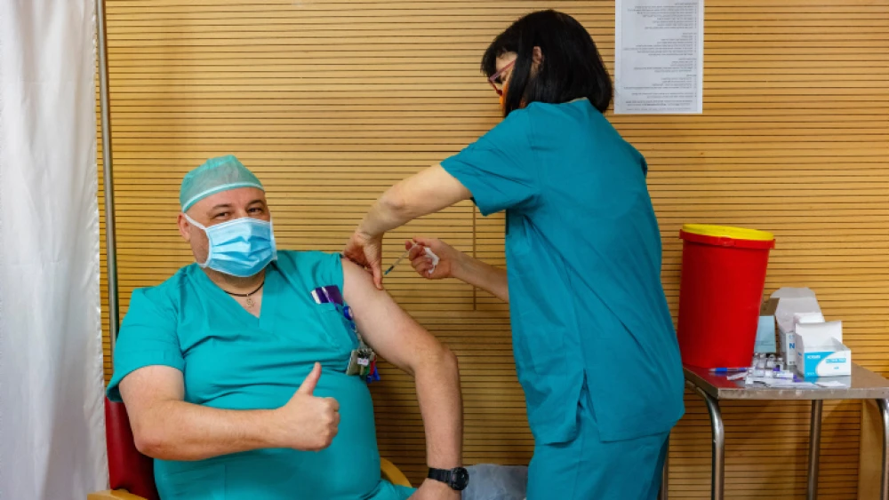 Hadassah Medical Center medical staff and families members receive their fourth dose of the COVID-19 vaccine, at the Hadassah Medical Center, in Jerusalem, Jan. 6, 2022. Photo by Olivier Fitoussi/Flash90.