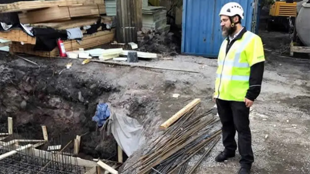 Rabbi Benyamin Wolff surveys the construction, which is now being done in tandem with archeologists. Credit. Chabad.org/News.