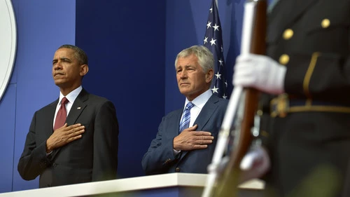 President Barack Obama and Secretary of Defense Chuck Hagel place their hands over their hearts as the National Anthem is played in Washington, DC, on July 27, 2013. Obama's selection of Hagel was heavily criticized by the pro-Israel community, and now fresh concerns have arisen over the new appointment of Robert Malley—who had a falling out with the 2008 Obama presidential campaign over his meeting with the terror group Hamas—as a senior director at the National Security Council, where he will manage relations with the Persian Gulf states. Credit: DoD photo by Glenn Fawcett.