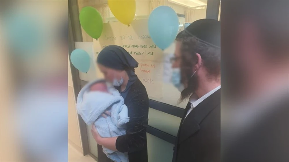 Liba Ahuva Schreiber leaves hospital with her child (Shaarei Tzedek Medical Center)