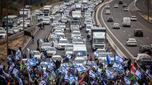 Reservists and veterans from the Israel Defense Forces, in addition to activists, block Road 1, the main highway to Jerusalem, during a protest against the government's planned judicial reforms, Feb. 9, 2023. Photo by Yonatan Sindel/Flash90.