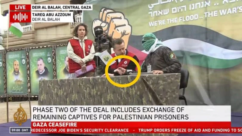 ICRC official Nour Khadam shakes hands with a Hamas member as ICRC official Stephanie Eller stands in the background during a hostage transfer ceremony in Khan Yunis, the Gaza Strip, Feb. 8, 2025. Credit: Screenshot via The Washington Free Beacon.