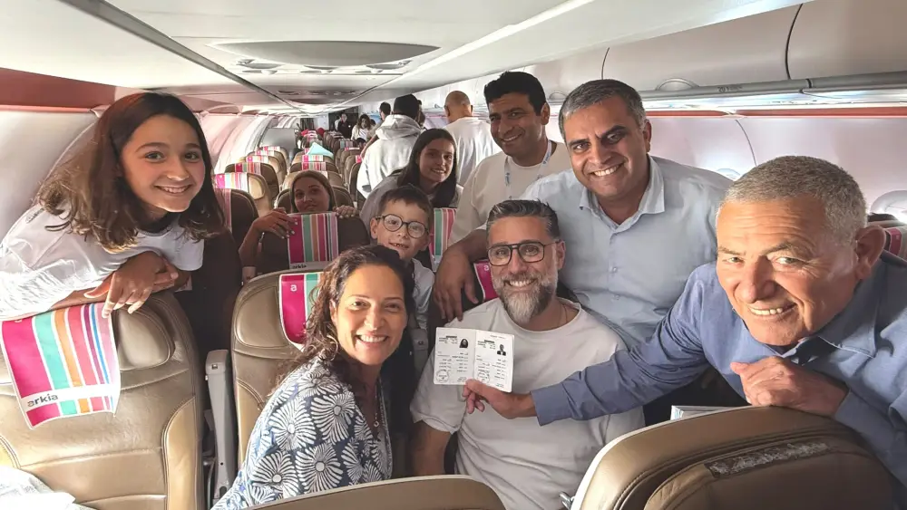Chairman of the Jewish Agency Doron Almog, Minister of Aliyah and Integration Ofir Sofer and a new olim family from France