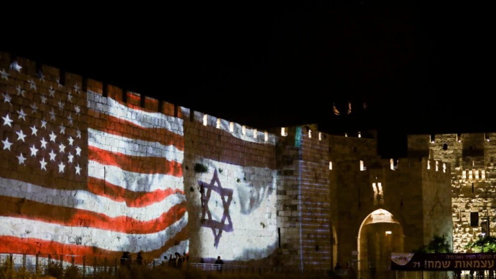 The Israeli and the American flags are screened on the walls of Jerusalem's Old City, on May 14, 2019. Photo by Aharon Krohn/Flash90.