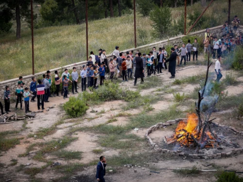Children and their parents gather around a bonfire ahead of the Jewish holiday of Lag Ba'omer, in the northern Israeli city of Tzfat, May 8, 2023. Photo by Gershon Elinson/Flash90