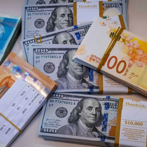 Illustration of American 100 dollar bills, 100 and 200 shekel bills and 50 euro bills, May 19, 2025. Photo by Nati Shohat/Flash90.