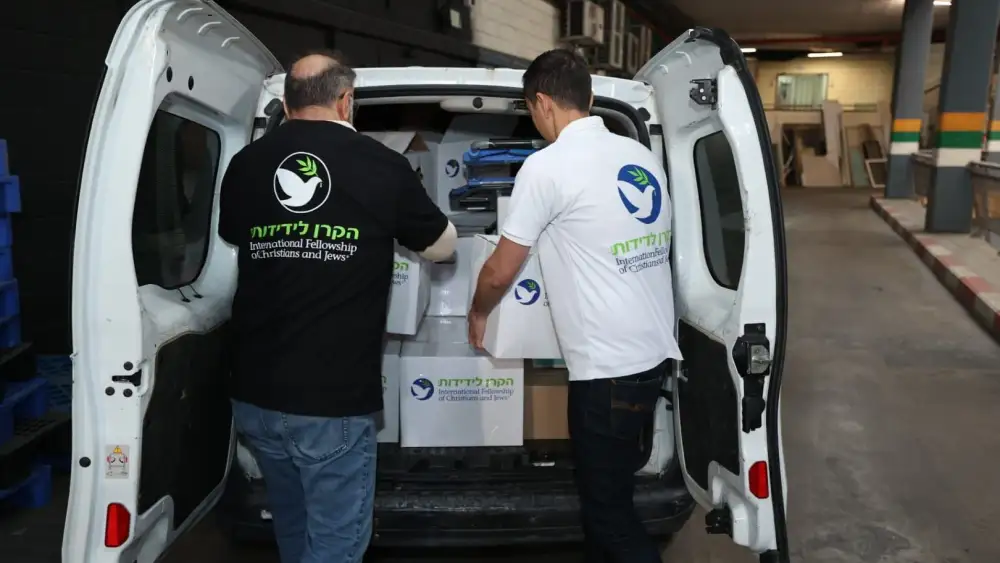 International Fellowship of Christians and Jews' (IFCJ) volunteers removing packages from a van. Photo by Elad Zagman/IFCJ.