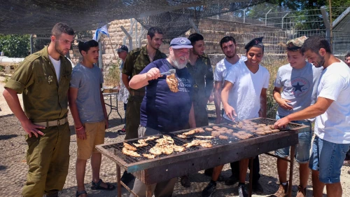 Israeli soldiers enjoy a barbecue prepared for them in honor of Israel's Independence Day in 2016 at the "soldiers corner," a place to rest and eat at the Gush Etzion junction. Credit: Gershon Elinson/Flash90.