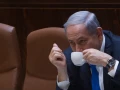Israeli Prime Minister Benjamin Netanyahu seen drinking coffee during a plenum session in the assembly hall of the Israeli parliament on June 17, 2015. Photo by Miriam Alster/Flash90.