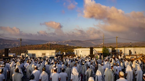 Israelis attend a special prayer event in the newly recognized town of Evyatar in Samaria, July 7, 2024. Photo by Chaim Goldberg/Flash90.