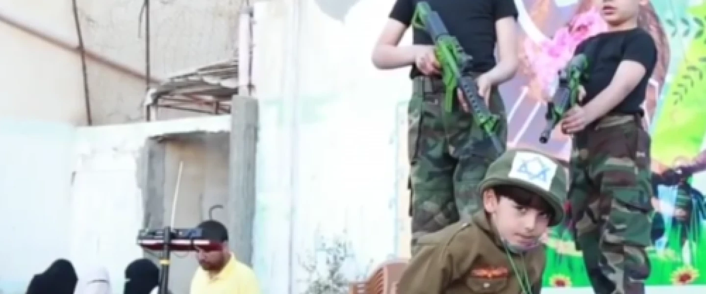 A school play performed at the UNRWA Nuseirat School in Gaza, in which students hold an Israeli hostage at gunpoint, April 2016. Credit: Center for Near East Policy Research.