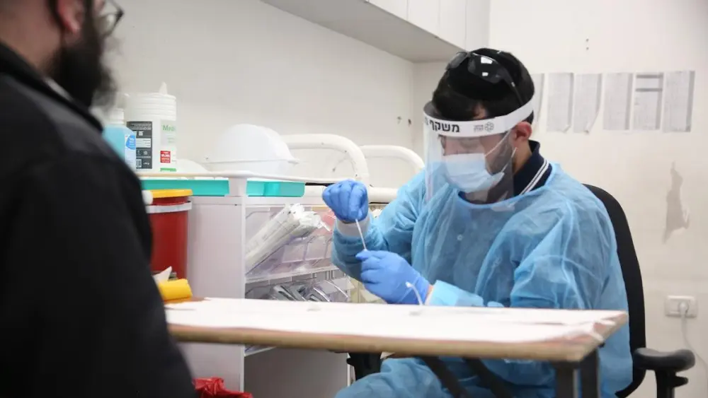 A United Hatzalah volunteer performs a COVID-19 test.