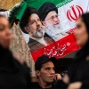 An Iranian flag bearing depictions of Iranian Supreme Leader Mojtaba Khamenei and his slain father and predecessor, Ali Khamenei, is displayed during a Shiite Muslim procession ahead of the Muharram season of mourning in Baghdad, June 21, 2026. Photo by Ahmad Al-Rubaye/AFP via Getty Images.