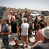 Israeli soldiers detain Israeli left-wing activists during a tour conducted by NGO Breaking the Silence in Mitzpe Yair, near Hebron in Judea and Samaria, on Aug. 31, 2018. Photo by Wisam Hashlamoun/Flash90.