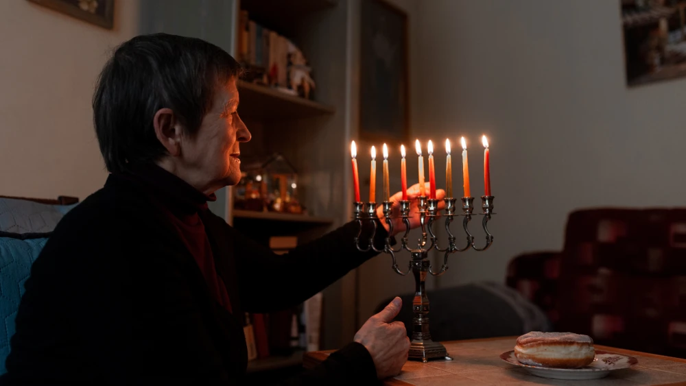 Galina Kovalenko, one of more than 40,000 Jews in Ukraine currently cared for by the American Jewish Joint Distribution Committee (JDC) as part of their Ukraine crisis response efforts, celebrates Hanukkah in her home in of Lviv, Ukraine. Credit: Yura Malenko.