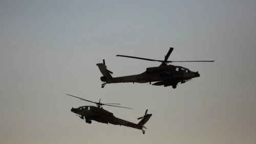 Israeli AH-64 Apache Longbow helicopters take part in an air show for a graduation ceremony at the Hatzerim base in the Negev Desert, near the southern Israeli city of Beersheva, on Dec. 31, 2015. Photo by Lior Mizrahi/Flash90.