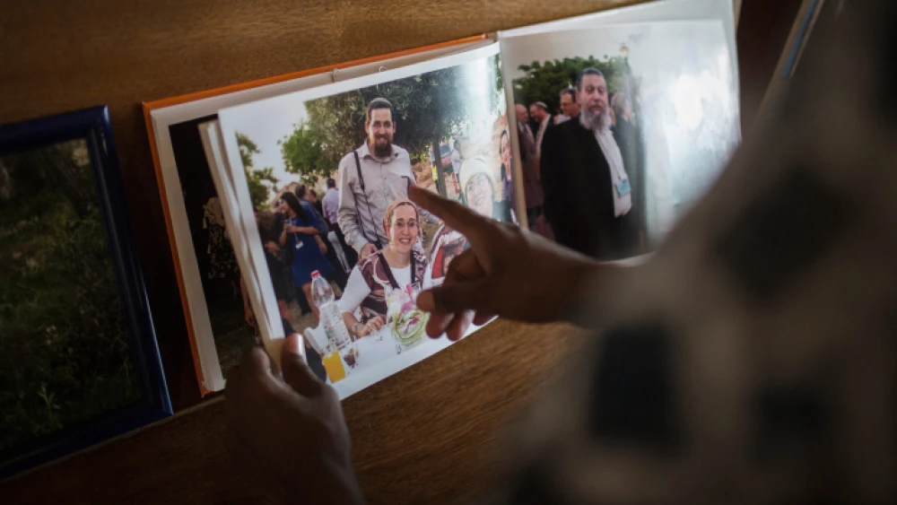 Friends and family look at pictures of Eitam and Na'ama Henkin, an Israeli couple shot and killed in Itamar, at their shiva in Jerusalem on Oct. 7, 2015. Photo by Hadas Parush/Flash90.