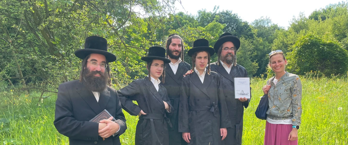 Polish tour guide Janina Naskalska-Babik, who digitized the names of more than 9,000 Jews buried at the demolished historic cemetery at Plaszow, with the group of New York hassidim, June 19, 2026. Credit: Courtesy.