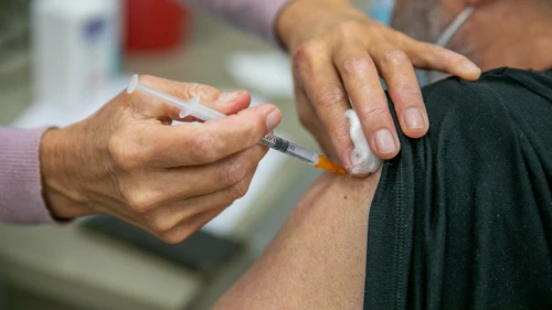 An Israeli receiving a COVID-19 vaccine, at the Maccabi Healthcare Services vaccination center in Modi'in, on Dec. 24, 2020. Photo by Yossi Aloni/Flash90.
