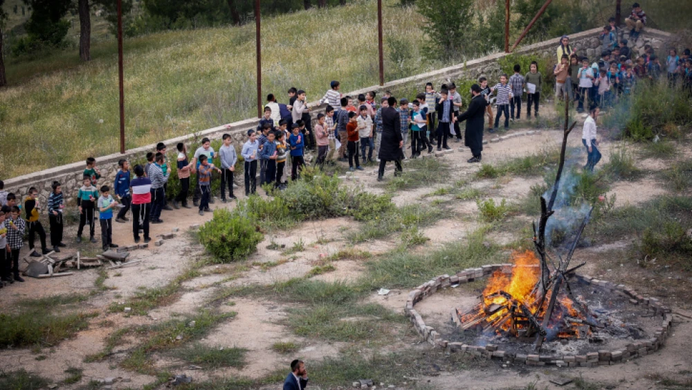 Children and their parents gather around a bonfire ahead of the Jewish holiday of Lag Ba'omer, in the northern Israeli city of Tzfat, May 8, 2023. Photo by Gershon Elinson/Flash90