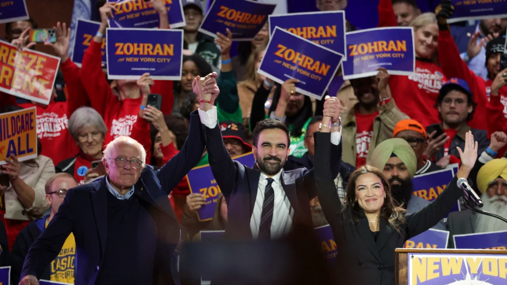 New York State Assemblyman Zohran Mamdani with Sen. Bernie Sanders (I-Vt.) and Rep. Alexandria Ocasio-Cortez (D-N.Y.) at the end of a campaign rally for his New York City mayoral campaign, Oct. 26, 2025. Photo by Angela Weiss/AFP/Getty Images.