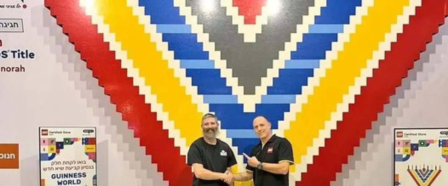 The massive LEGO menorah with Yitzchok Kasowitz (left), founder of Jbrick, and the manager of LEGO Store Tel Aviv. Source: Courtesy of Yitzchok Kasowitz.