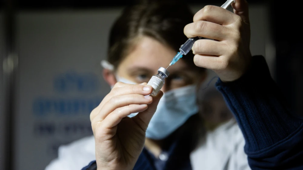 A medical worker prepares a COVID-19 vaccine injection at a vaccination center in Jerusalem, Feb. 4, 2021. Photo by Yonatan Sindel/Flash90.