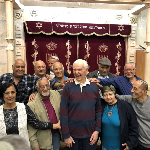 Capt. Elgen Long is embraced by Yemenite Jews during a visit to Israel last fall. Credit: Shahar Azani.