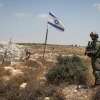 An Israeli soldier stands guard at the site of a car-ramming attack in Elazar, Gush Etzion, Aug. 18, 2019. Photo by Gershon Elinson/Flash90.