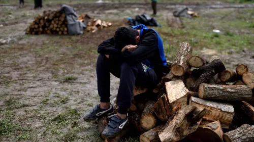 A young Syrian refugee takes a rest at a firewood distribution point at Idomeni refugee camp on May 3, 2016. Photo: Gili Yaari/Flash90