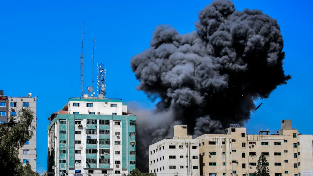 Smoke rising from the Al-Jalaa tower in Gaza City after an Israeli airstrike, which according to the Israel Defense Forces housed Hamas intelligence and weaponry. Several media outlets also had offices in the building, including the Associated Press and Al Jazeera. May 15, 2021. Photo by Atia Mohammed/Flash90.