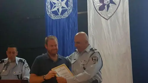 Ofek Kaufman earns an award for his quick action in helping a man who was fleeing from an attacker. Source: Israel Police.